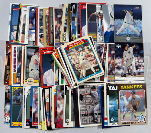 Collection of baseball trading cards featuring various new york Yankees players on a gray background.