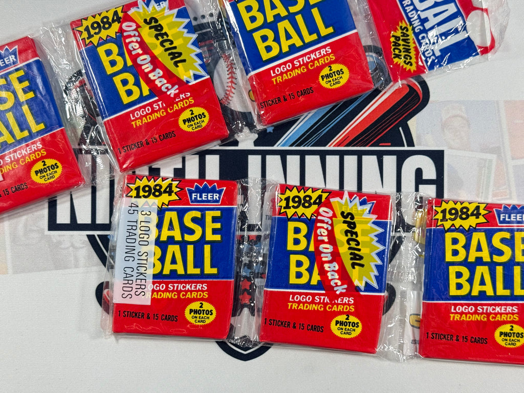 Collection of 1984 Fleer Baseball trading card packs on a white background
