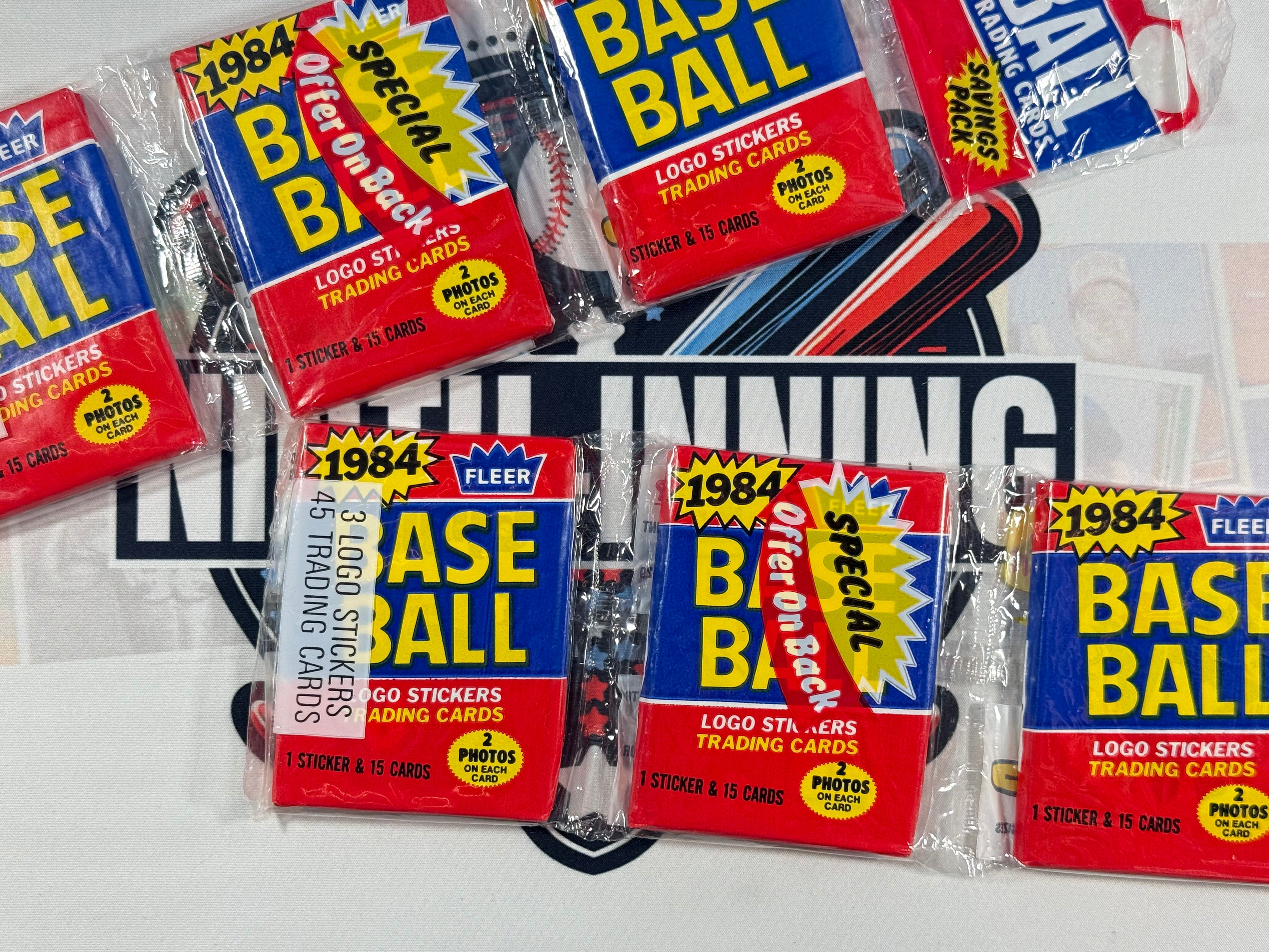 Collection of 1984 Fleer Baseball trading card packs on a white background