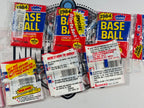 Collection of 1984 Fleer baseball trading card packs on a white background