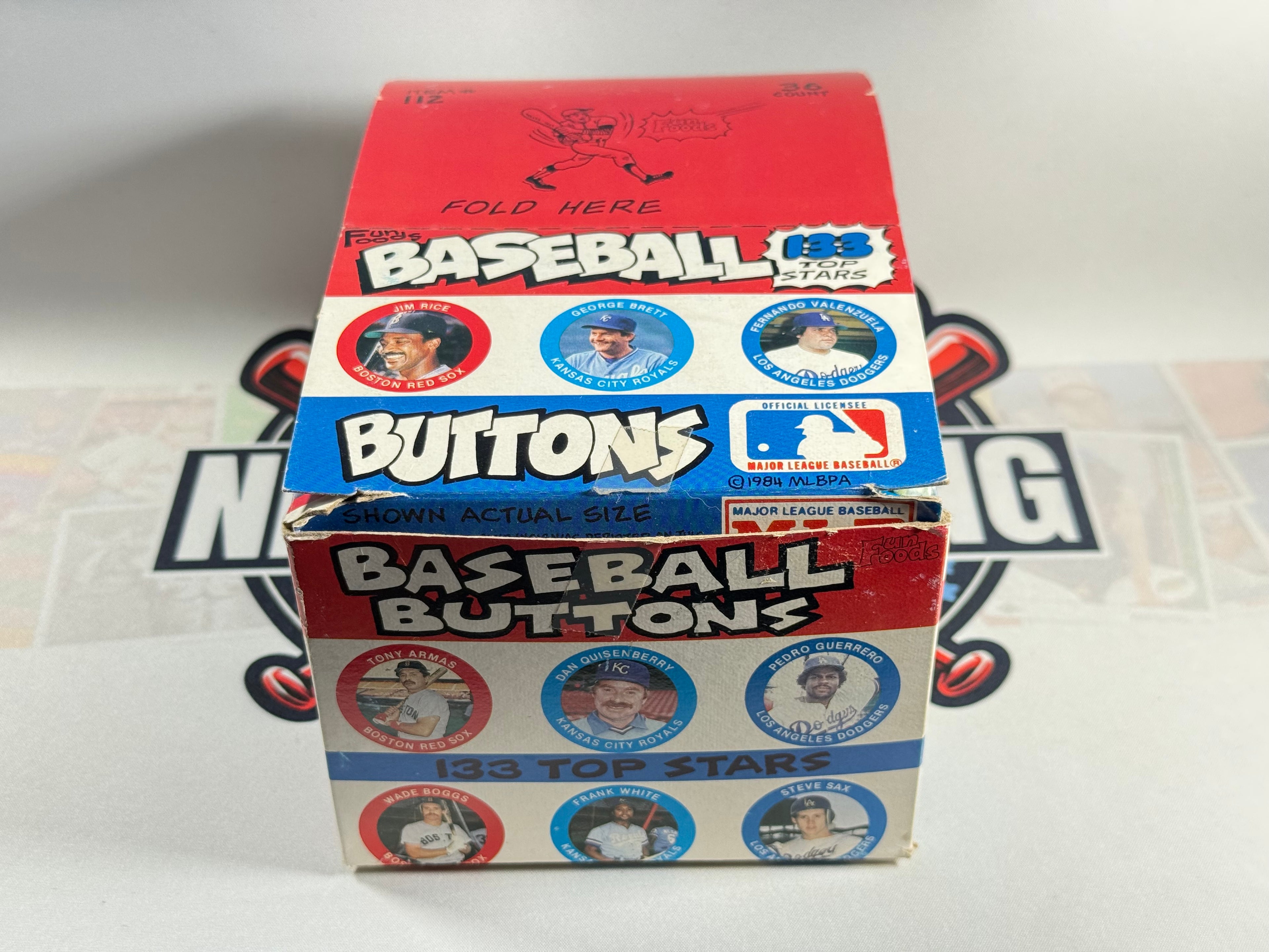 Box of baseball buttons with images of players on a white background
