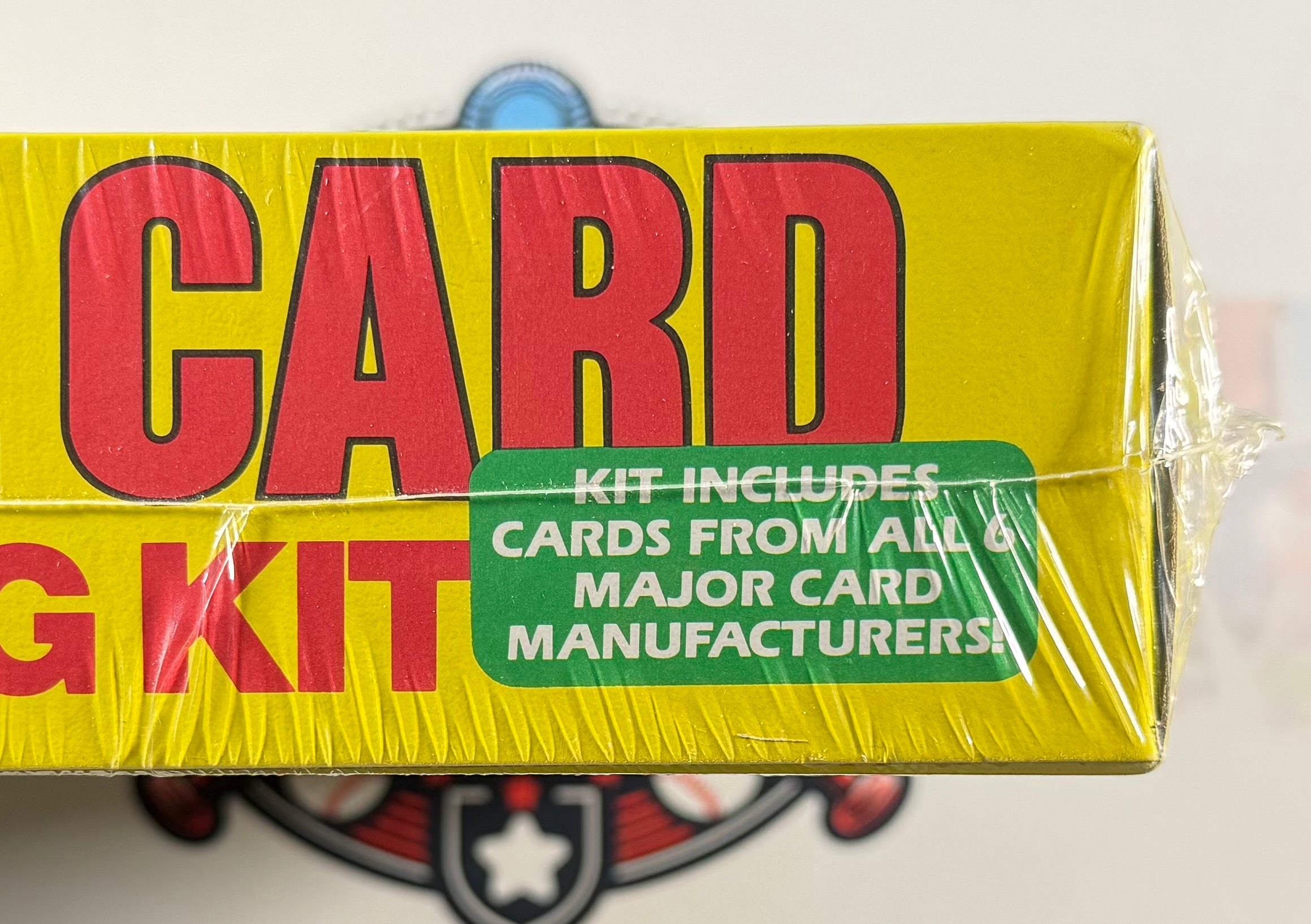 Yellow card kit packaging with red and green text on a white background