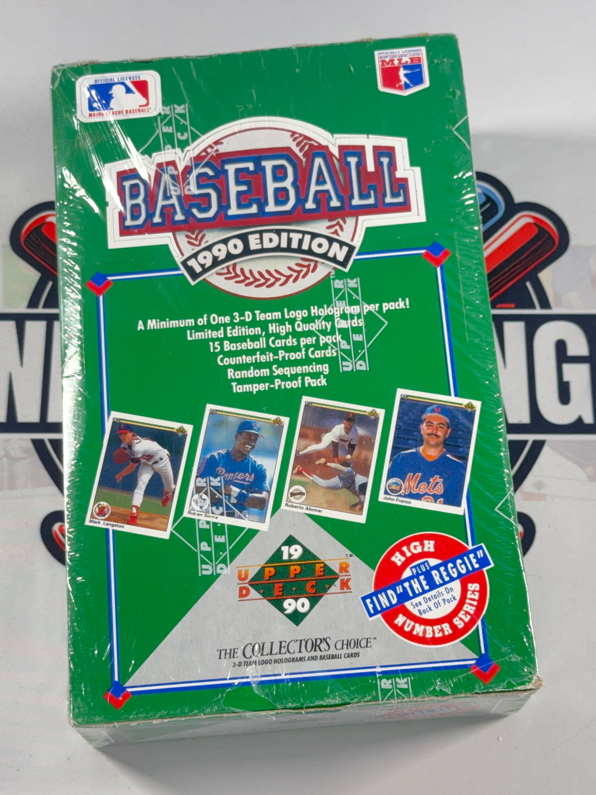 A sealed 1990 Upper Deck baseball trading card booster pack in its original green packaging, featuring team logos and player photos on the front.