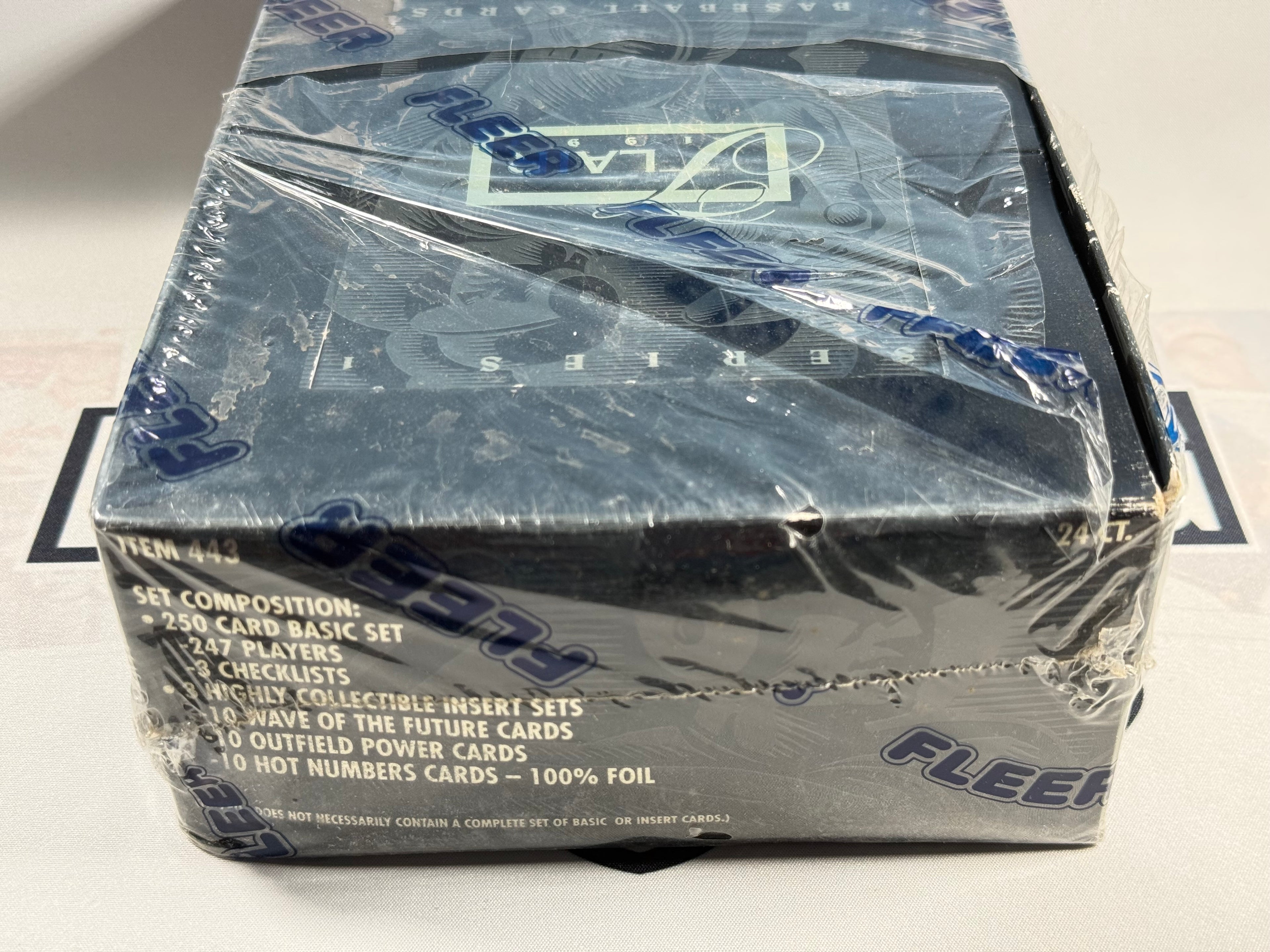 Sealed trading card box with clear plastic wrap on a white background