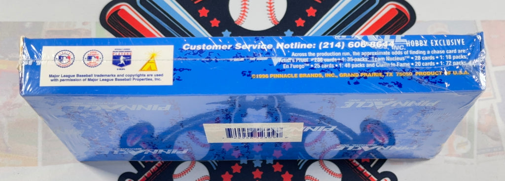 A blue cardboard product box wrapped in clear plastic, photographed from the back side. The box has white text, a white label with logos, and a blue baseball graphic.