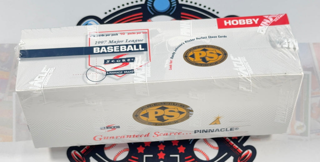 A sealed white box of Pinnacle Hobby Baseball Score 1997 Matted League Baseball cards, wrapped in clear plastic, with a baseball-themed circular mat underneath.