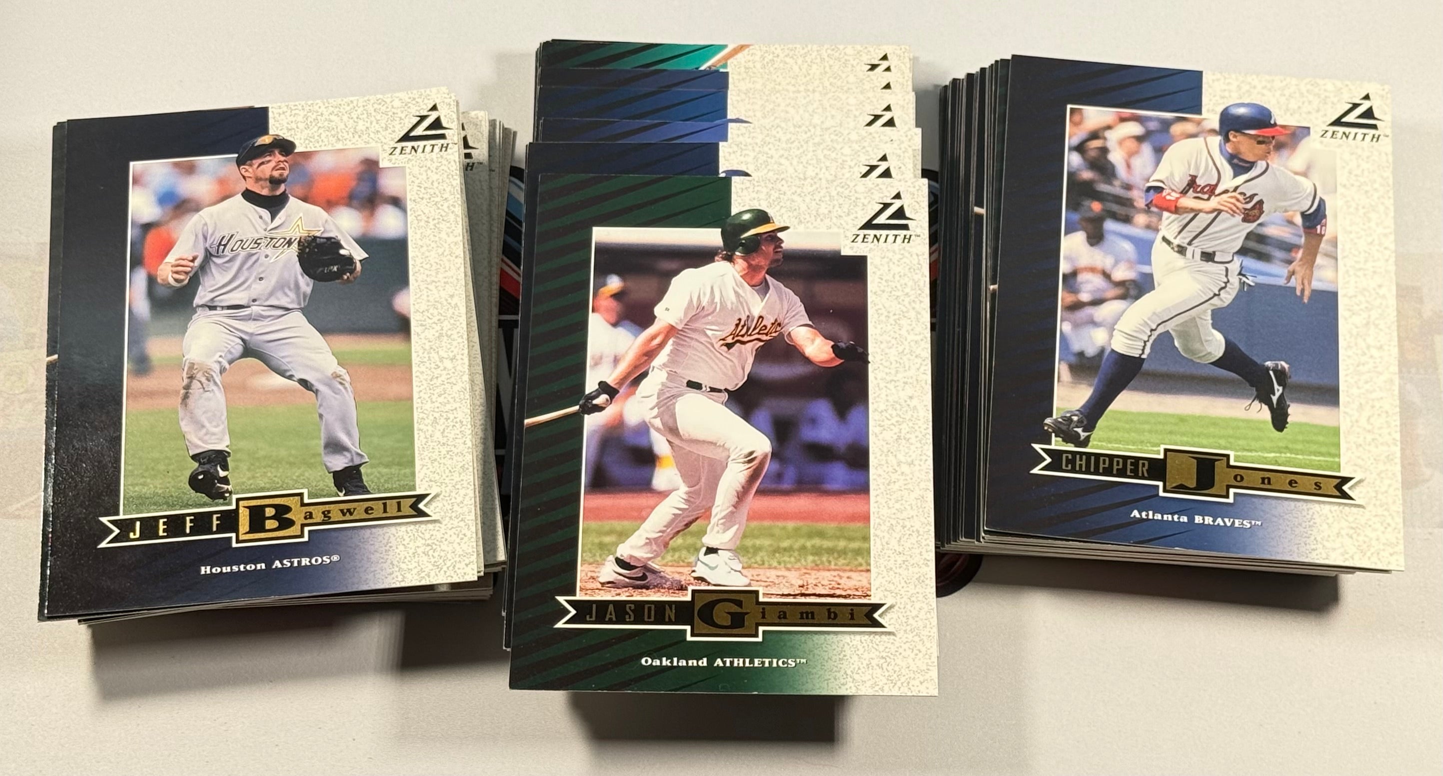 Three baseball trading cards featuring different players on a white background