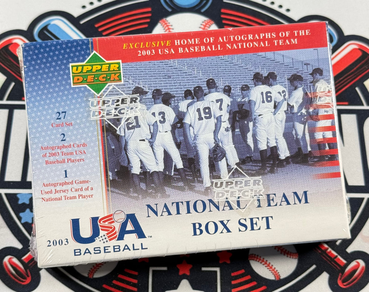 A sealed 2003 Upper Deck USA Baseball National Team Box Set trading card box, photographed on a baseball-themed mat. The box features a vintage photo of a baseball team, red and blue text, and the Upper Deck logo.