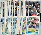 Collection of baseball trading cards featuring players, including Wade Boggs, on a gray surface.